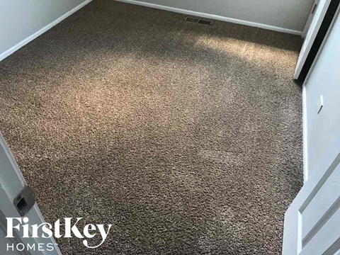 a carpeted floor in a room with a white door