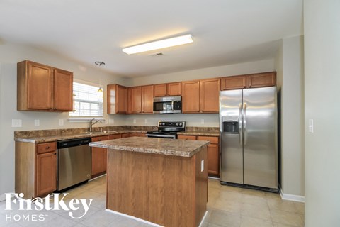 A kitchen with wooden cabinets and stainless steel appliances.
