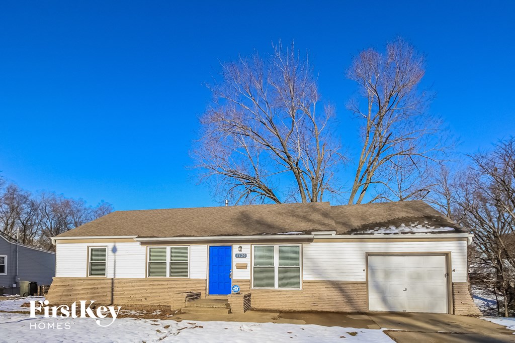 a small white house with a blue sky in the background