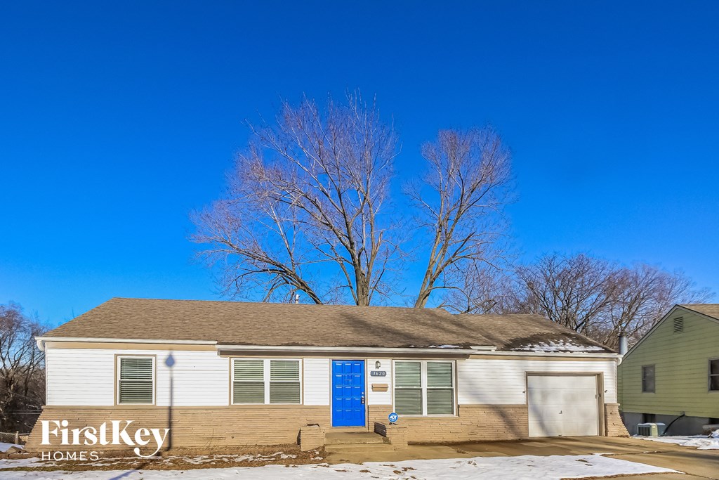 front view of a white house with a blue sky in the background