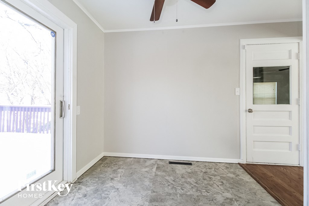 a room with a white door and a carpeted floor and a door to a