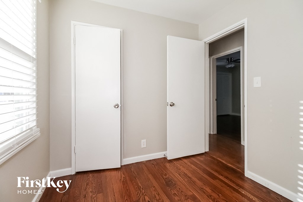 a bedroom with two closets and a door to a hallway