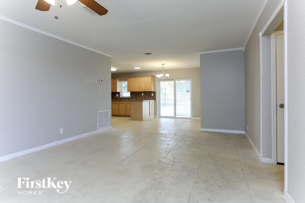 an empty living room and kitchen in a new home