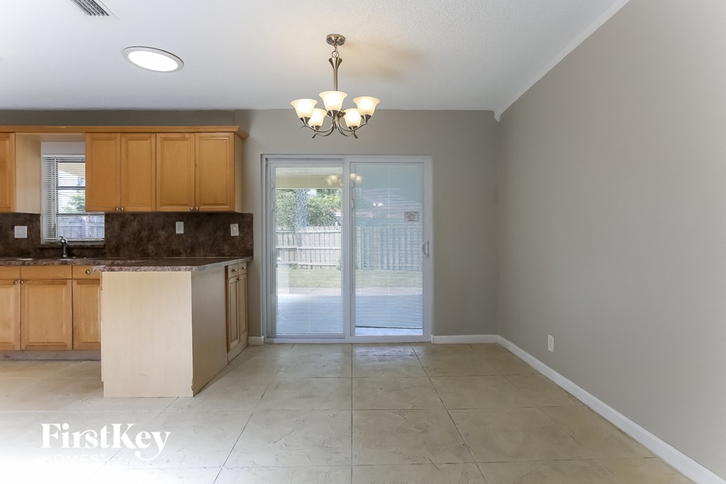 an empty kitchen with a door to a patio