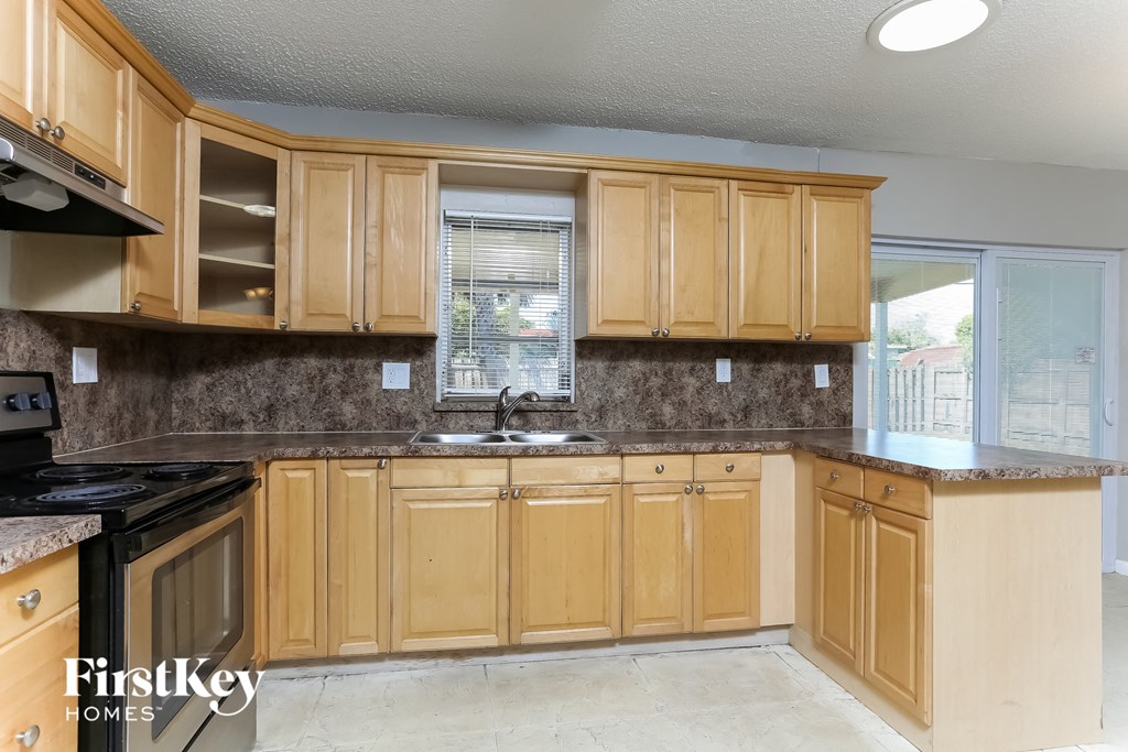 a kitchen with wooden cabinets and a sink