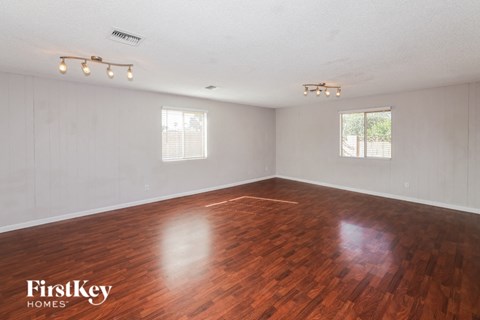 the living room of an empty house with wood floors