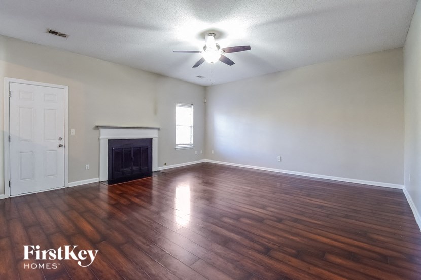 the living room with hardwood flooring and a fireplace