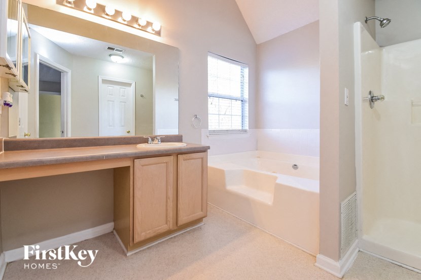 a bathroom with a sink and a tub and a mirror