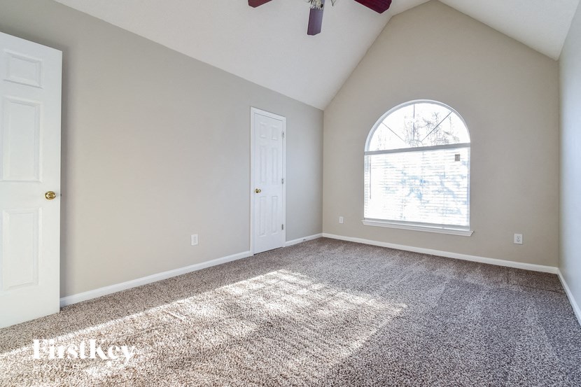 an empty room with carpet and a window