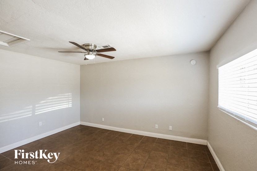 a living room with a ceiling fan and a window