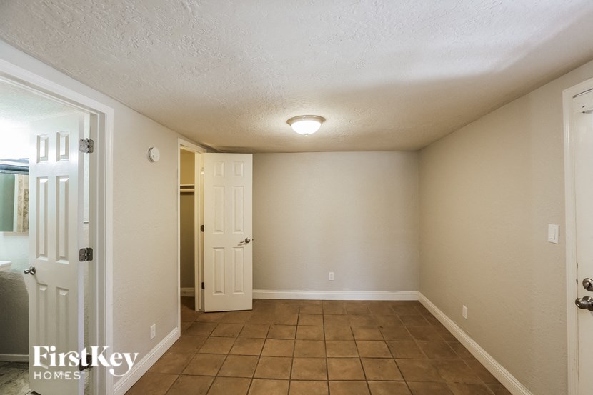 the living room of an empty house with a door to a closet