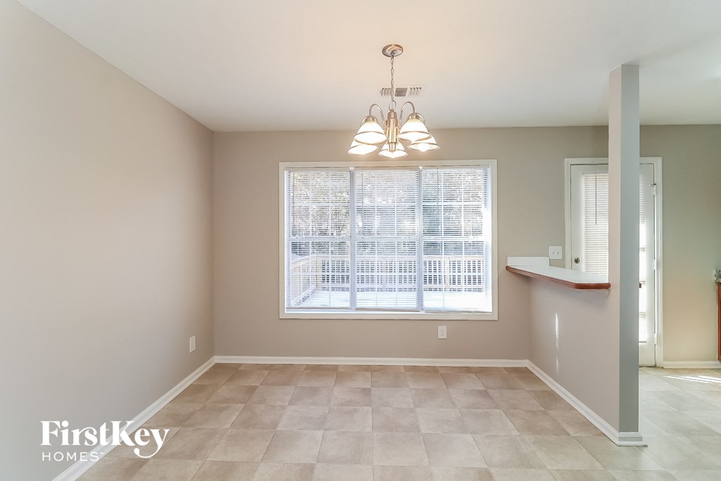 an empty dining room with a large window