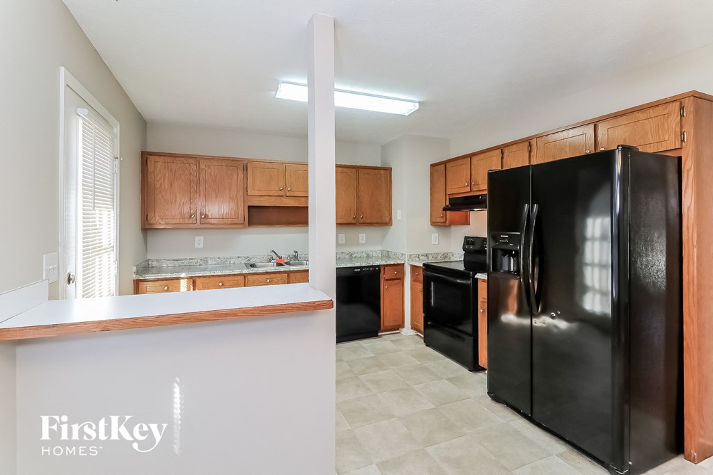 a kitchen with black appliances and wooden cabinets
