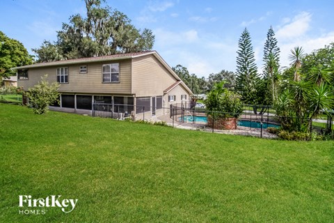 a backyard with a pool and a house