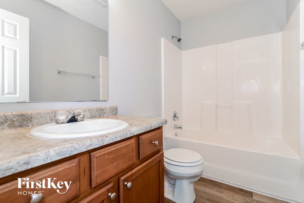 A bathroom with a sink, toilet and bathtub.