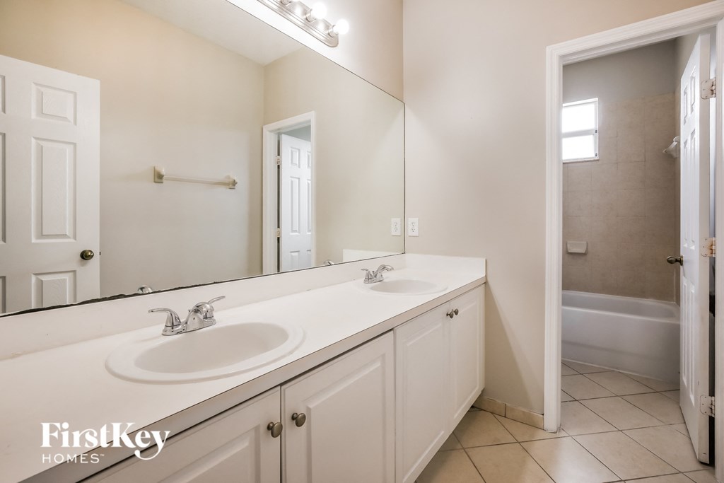 a bathroom with two sinks and a large mirror