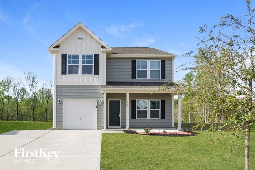 a house with a white garage door and a lawn