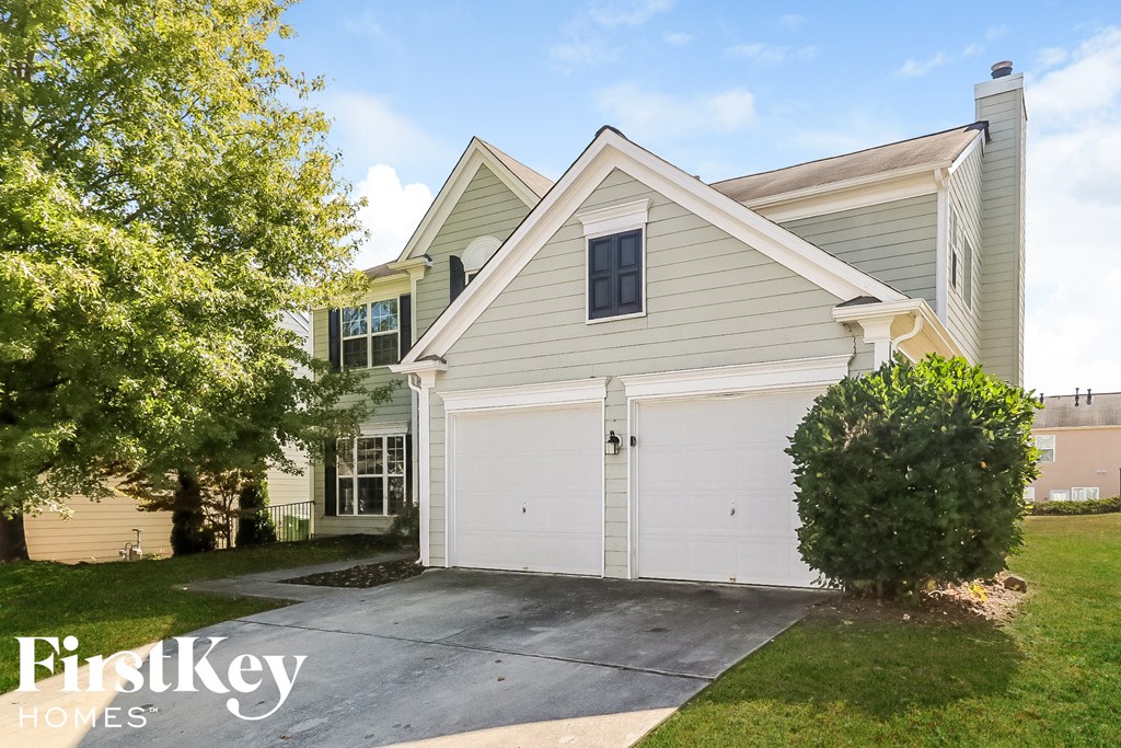 a white garage door in front of a house