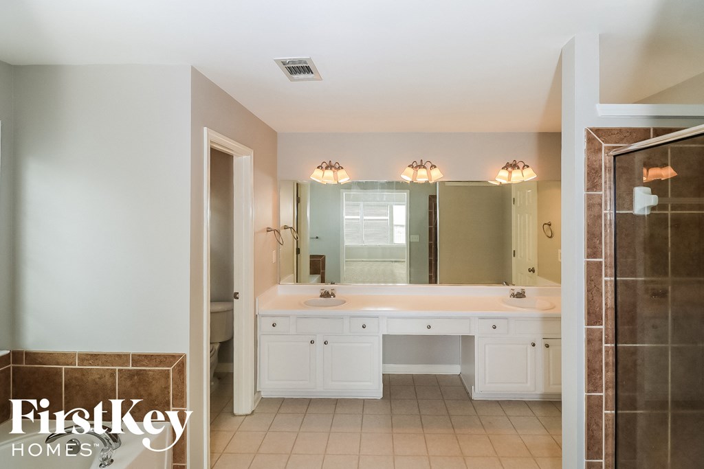 a bathroom with two sinks and a large mirror