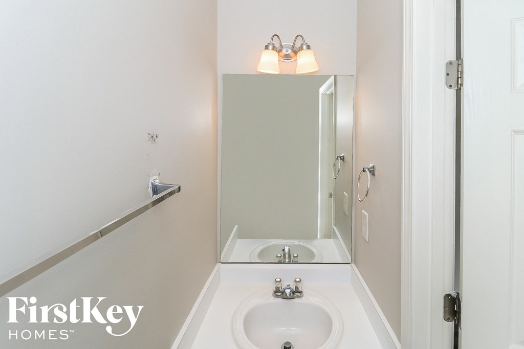 a small bathroom with a sink and a mirror