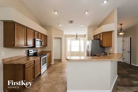 A kitchen with brown cabinets and a white island.