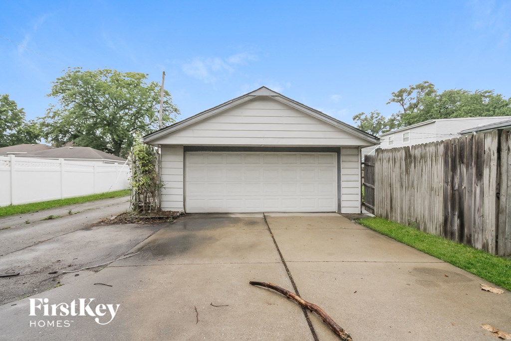 the driveway of a garage with a white garage door