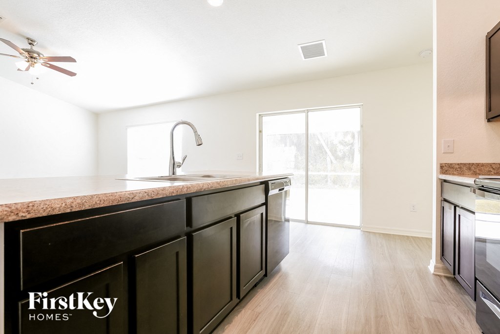 A kitchen with a FirstKey Homes logo.