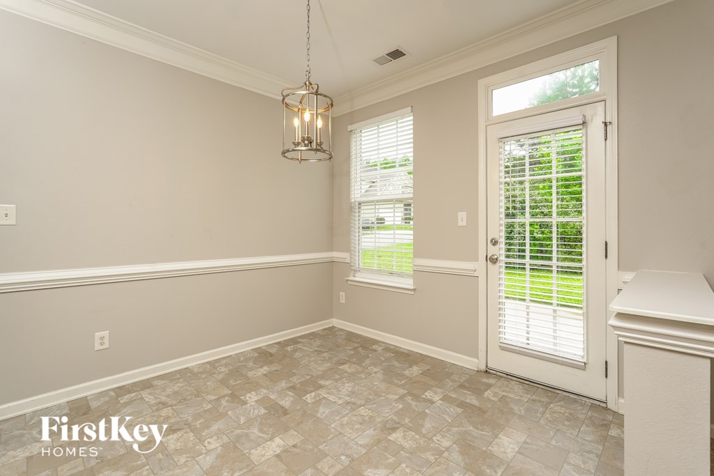 A room with a tiled floor and a door leading outside.