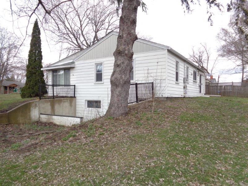 a white house with a tree in front of it