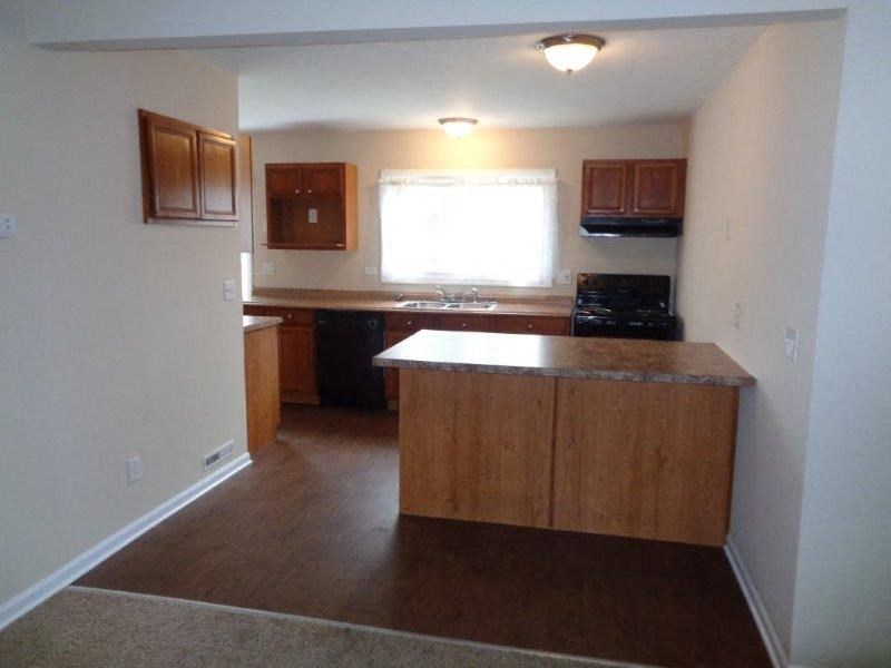 an empty kitchen with an island in the middle