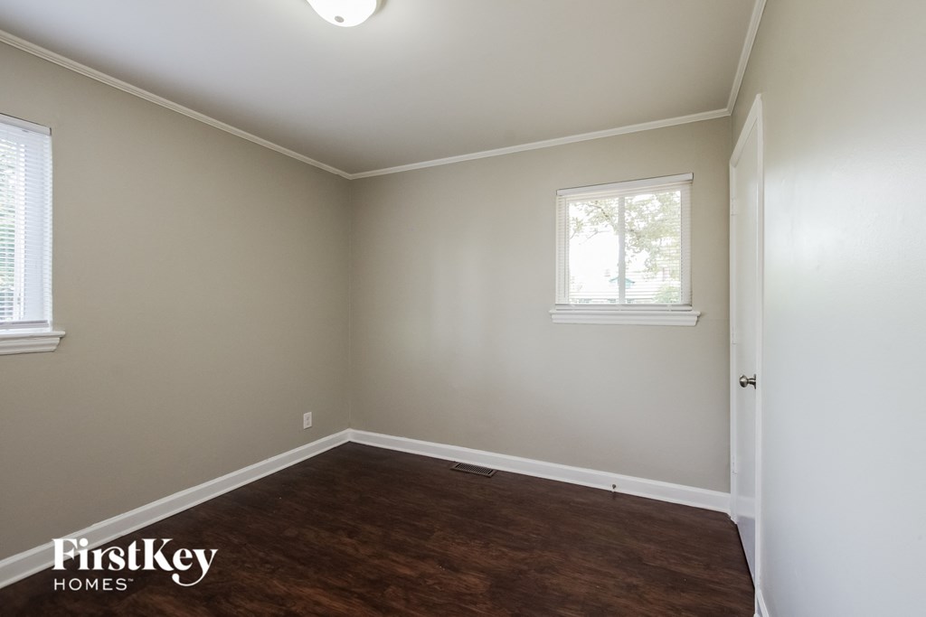 a empty room with wooden floors and a window