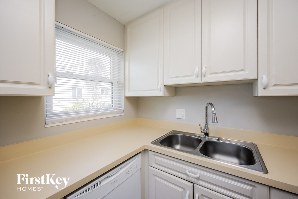 A kitchen with a sink and cabinets.