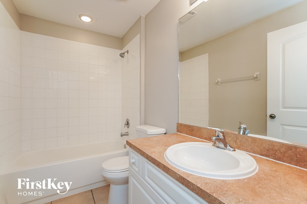 a bathroom with a sink and a toilet and a shower