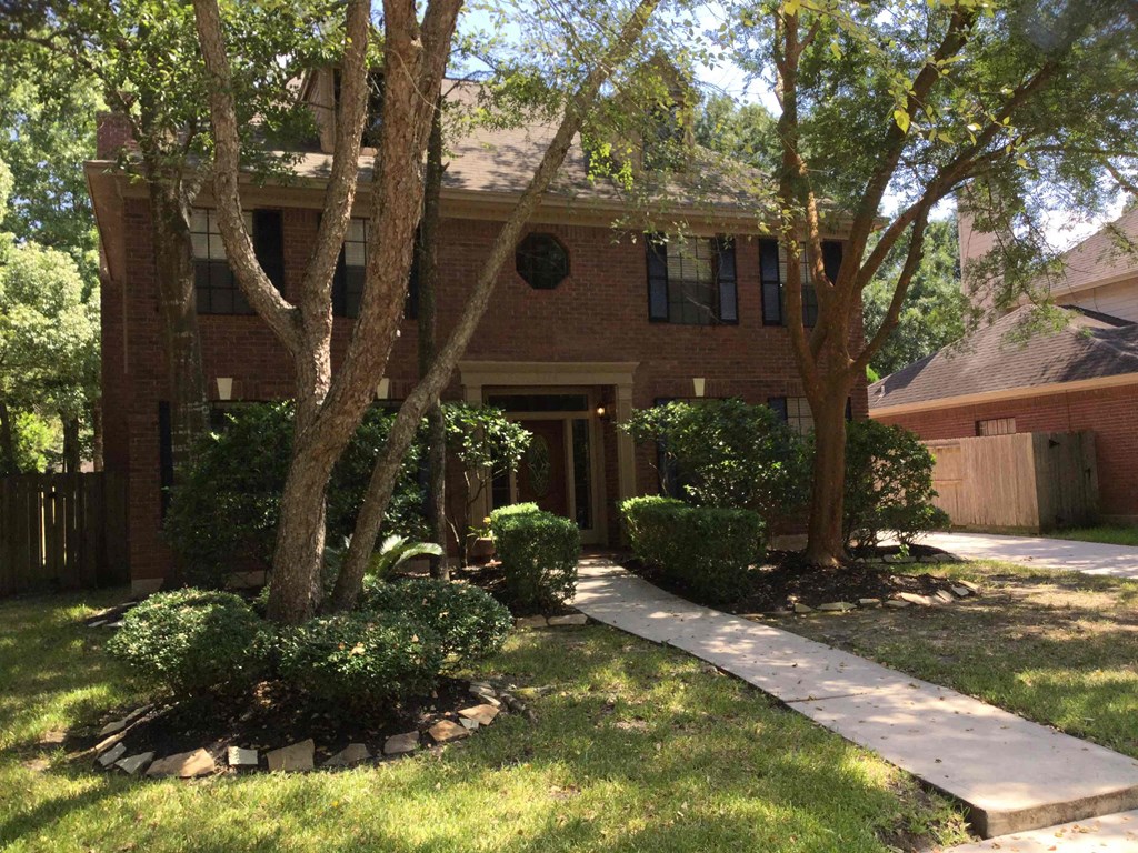 A house with a tree in front of it.