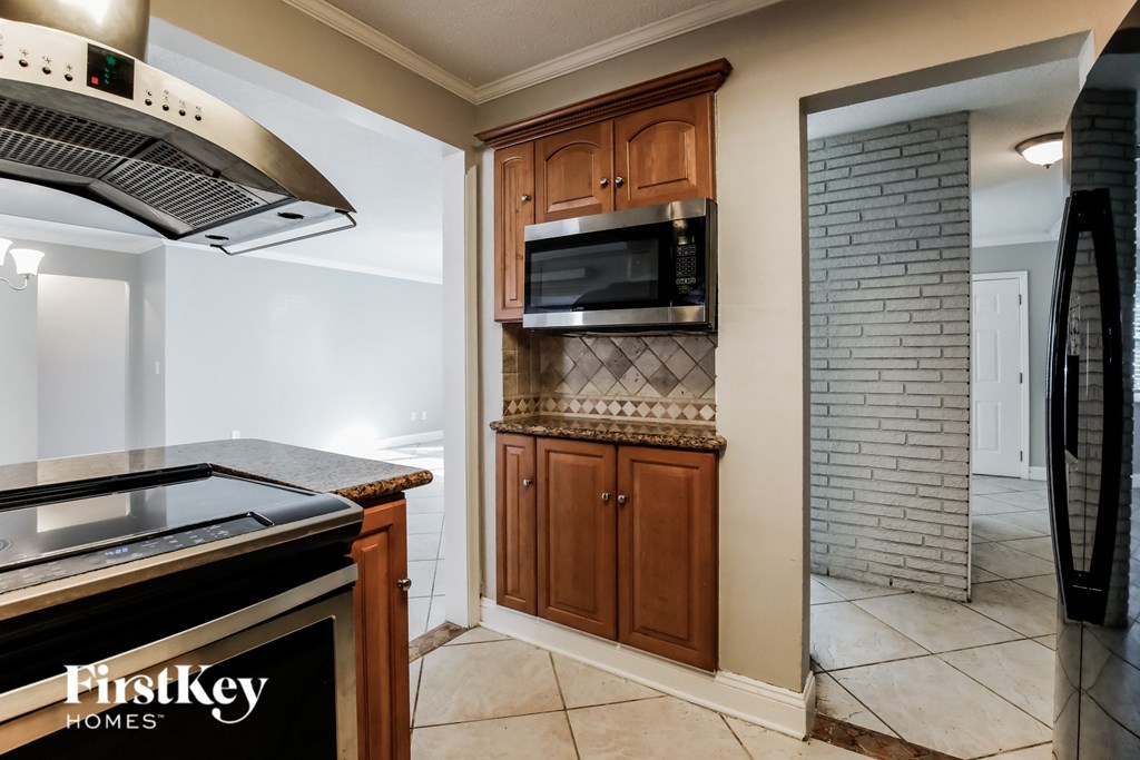 a kitchen with a stove top oven and a microwave