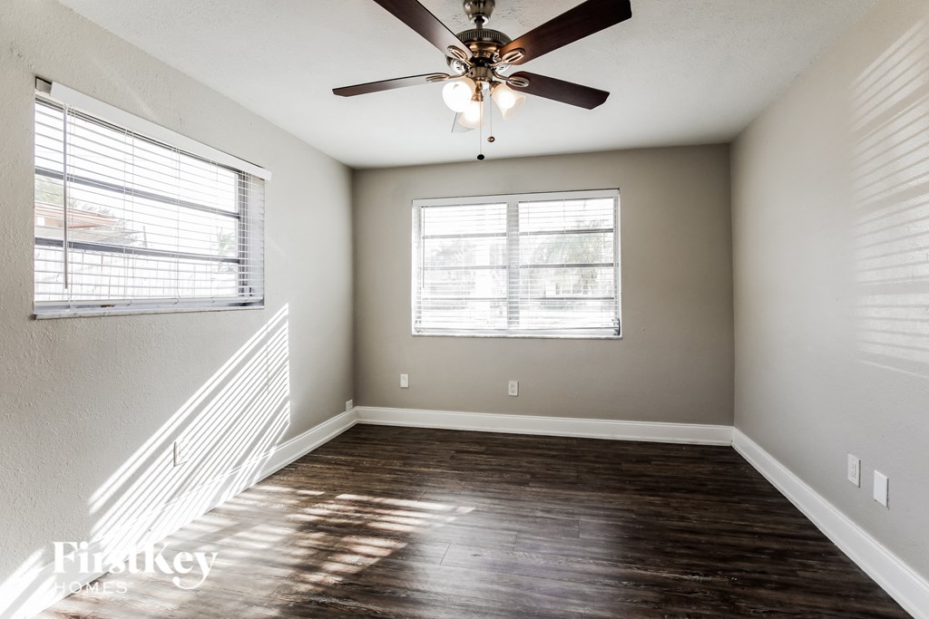 a living room with a ceiling fan and a window