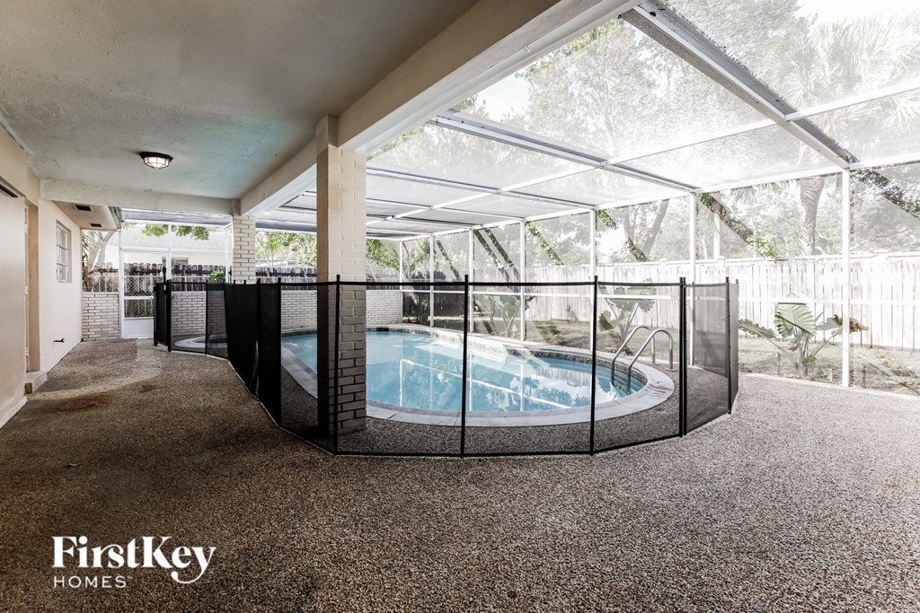 a jacuzzi in a glass enclosure in a house with a pool