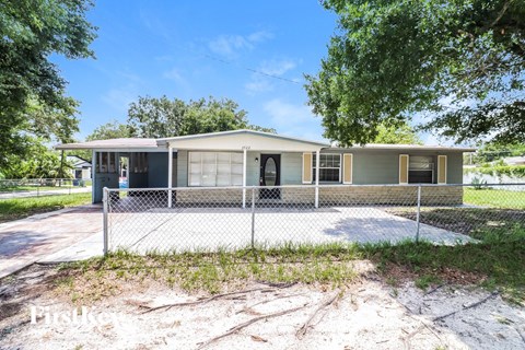 a house with a fenced in yard and a chain link fence