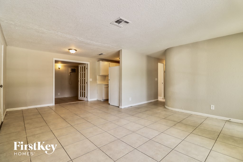 the living room and dining room are spacious and clean with tile flooring