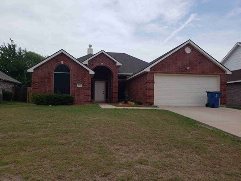 a house with a driveway and a garage door