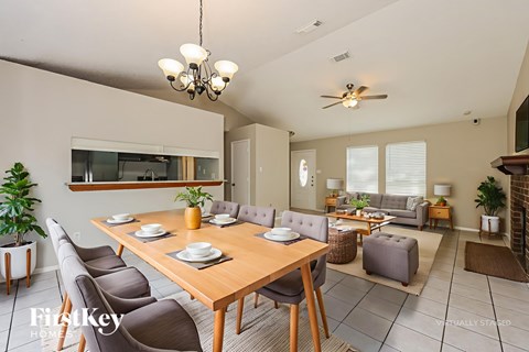 A dining room with a wooden table and chairs.