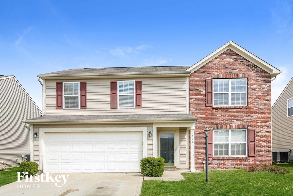 a brick house with a white garage door