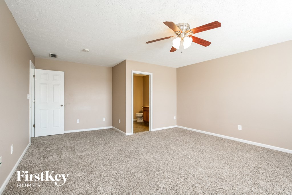 the master bedroom is spacious and has a ceiling fan