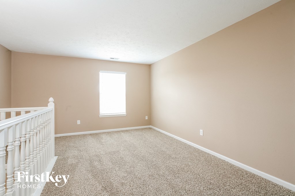 a nursery with a crib and a carpeted floor and a window