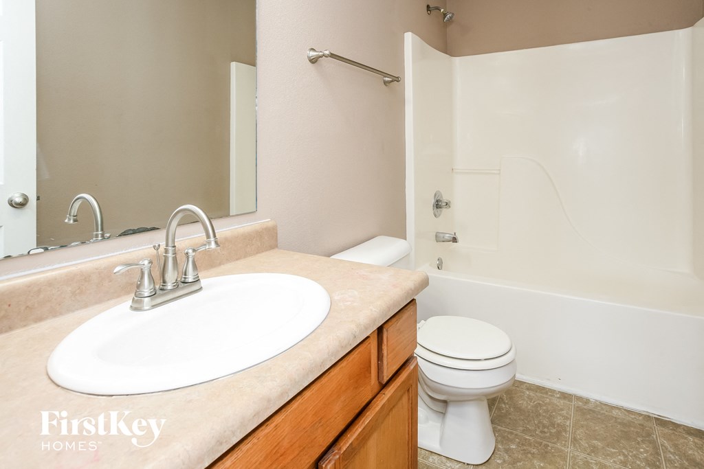 a bathroom with a sink and a toilet and a mirror