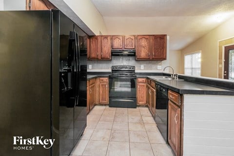 a kitchen with black appliances and wooden cabinets