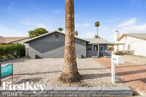 A house with a palm tree in front of it.