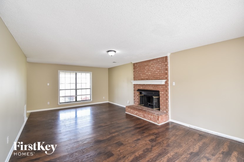 A room with a fireplace and a window.