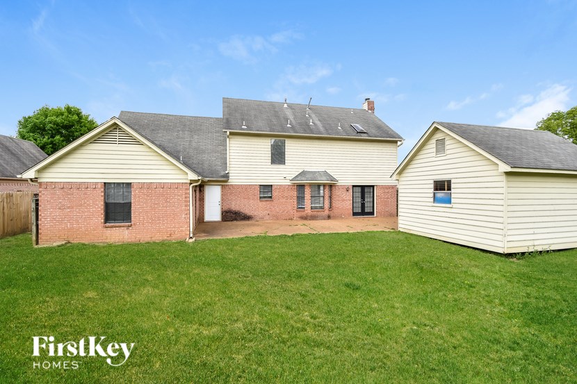 A house with a white and red brick exterior is for sale.