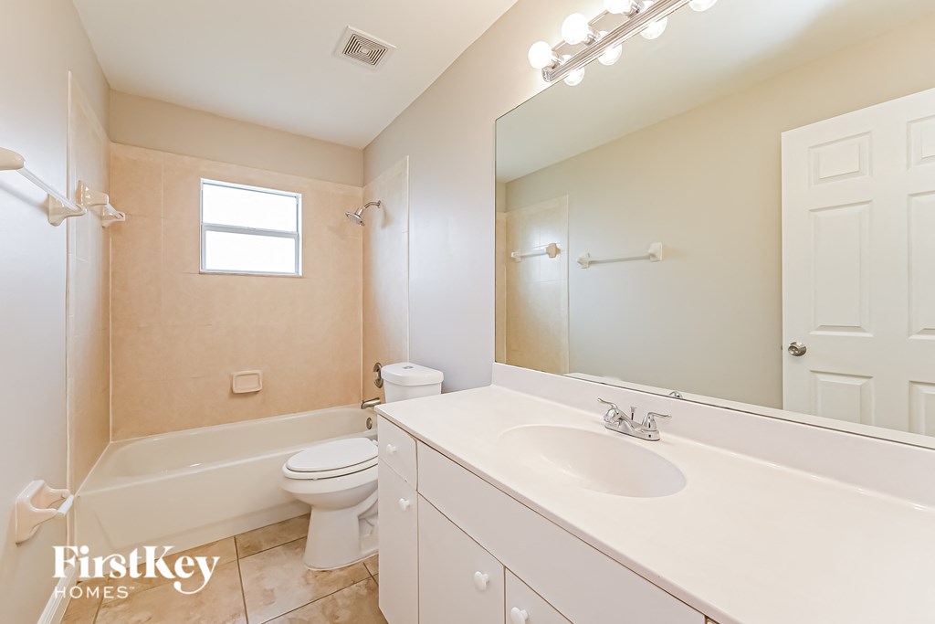 a bathroom with a sink and a toilet and a bath tub